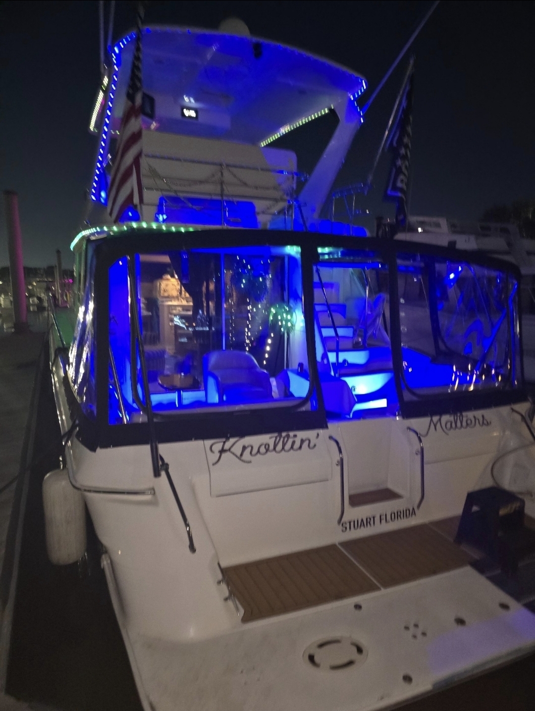 Sea Ya Later glowing blue at the dock after dark
