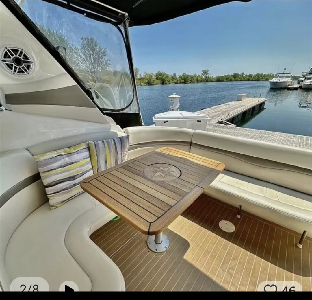 Teak table with compass rose inlay on the aft deck